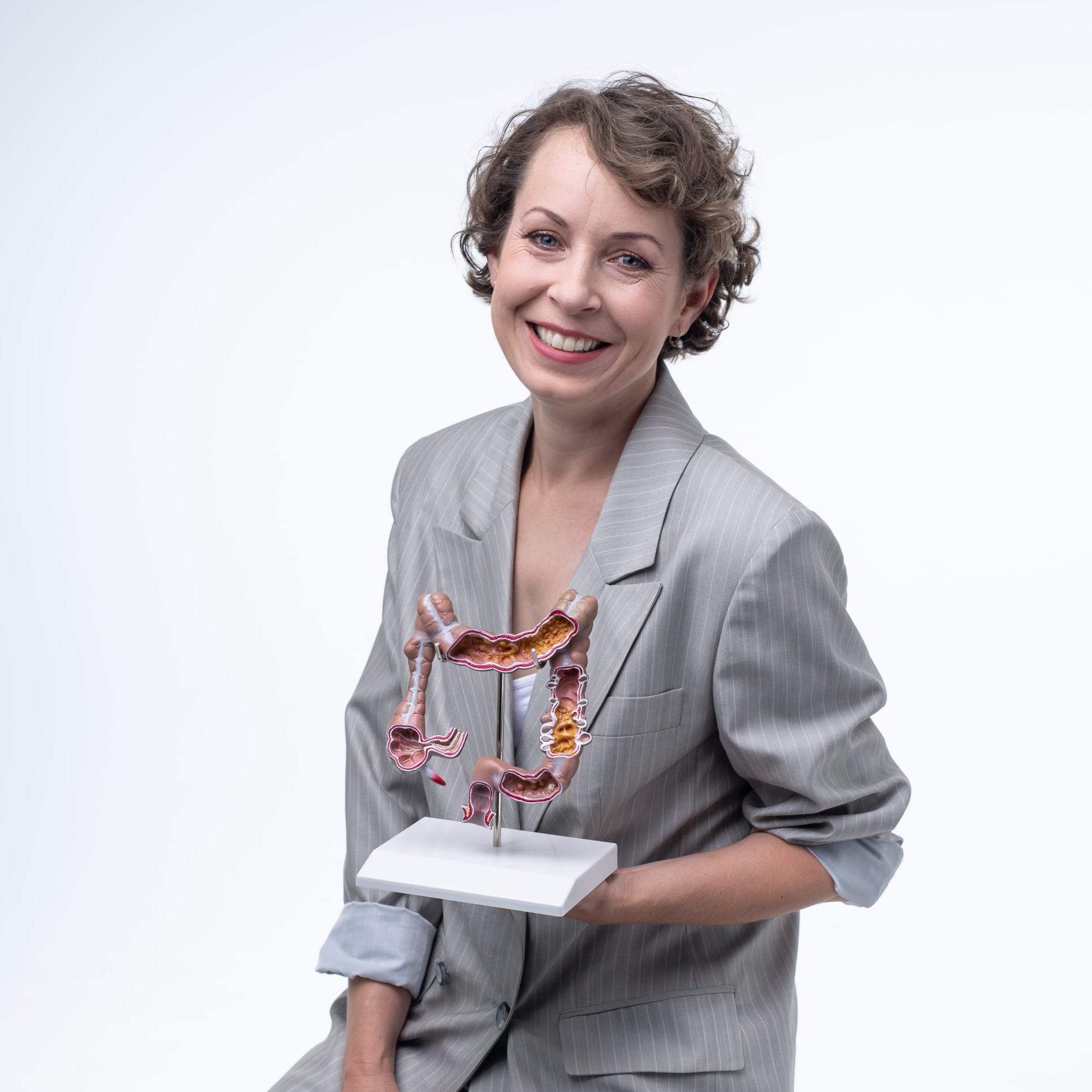 Profile photo of Veronika Vymetálková holding an anatomical model of the colon.